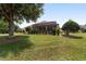 A lush backyard with mature landscaping overlooks a large field in this home's backyard at 8463 Sw 84Th Loop, Ocala, FL 34481