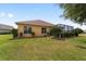Well-maintained backyard featuring lush green grass, landscaping, and screened-in patio at 8463 Sw 84Th Loop, Ocala, FL 34481