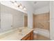 Well-lit bathroom features a tub/shower combo and large vanity with ample counter space at 8463 Sw 84Th Loop, Ocala, FL 34481