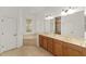 Primary bathroom featuring double sink vanity, soaking tub and linen closet at 8463 Sw 84Th Loop, Ocala, FL 34481