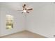 Neutral bedroom features a ceiling fan and a window offering natural light at 8463 Sw 84Th Loop, Ocala, FL 34481