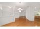 Elegant dining area showcasing hardwood floors, decorative chandelier, and an open layout at 8463 Sw 84Th Loop, Ocala, FL 34481