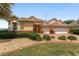 Charming home with lush landscaping, decorative rock beds, and a brick-accented exterior at 8463 Sw 84Th Loop, Ocala, FL 34481