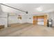 Well-lit garage featuring built-in cabinets, ample storage space, and a functional layout for parking and projects at 8463 Sw 84Th Loop, Ocala, FL 34481