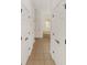 Hallway leading to a bath area with tile flooring and multiple linen closets at 8463 Sw 84Th Loop, Ocala, FL 34481