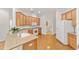 Well-lit kitchen featuring wood cabinets and granite countertops at 8463 Sw 84Th Loop, Ocala, FL 34481