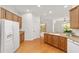 Bright kitchen features wood cabinets, light countertops, and stainless steel refrigerator at 8463 Sw 84Th Loop, Ocala, FL 34481