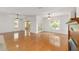Spacious living room with gleaming hardwood floors, ceiling fans, and lots of natural light at 8463 Sw 84Th Loop, Ocala, FL 34481