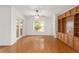Inviting living room featuring hardwood floors, built-in shelving, and a cozy window view at 8463 Sw 84Th Loop, Ocala, FL 34481