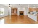 Bright living room with a fireplace, built-in shelving, and wood flooring at 8463 Sw 84Th Loop, Ocala, FL 34481