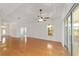 Bright living room boasts hardwood floors, tray ceiling, and sliding glass doors to lanai at 8463 Sw 84Th Loop, Ocala, FL 34481