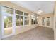 Bright sunroom featuring tile flooring, multiple windows, and a ceiling fan, perfect for relaxing and enjoying natural light at 8463 Sw 84Th Loop, Ocala, FL 34481