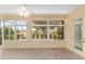Bright sunroom featuring tile flooring, multiple windows offering views of the surrounding greenery, creating a relaxing retreat at 8463 Sw 84Th Loop, Ocala, FL 34481