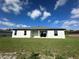 Beautiful home backyard with green grass, sliding glass door and windows at 10107 Sw 41St Ave, Ocala, FL 34476
