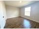 Neutral bedroom boasts wood-look tile floors and a window view, creating a bright and airy space at 10107 Sw 41St Ave, Ocala, FL 34476