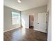 Bedroom with wood-look tile floors and a view of a bathroom and walk in closet at 10107 Sw 41St Ave, Ocala, FL 34476