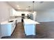 Modern kitchen with white cabinetry, stainless steel appliances, and a large center island at 10107 Sw 41St Ave, Ocala, FL 34476