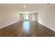 Spacious living room featuring wood floors and a large window with plenty of natural light at 10107 Sw 41St Ave, Ocala, FL 34476