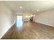 Spacious living room featuring wood floors that flow into the kitchen and a sliding glass door that leads to the backyard at 10107 Sw 41St Ave, Ocala, FL 34476