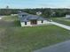 Aerial view of a modern single-Gathering home with a long driveway and spacious green lawn at 10107 Sw 41St Ave, Ocala, FL 34476