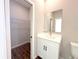 Well-lit bathroom with a modern vanity, mirror, and convenient access to a walk-in closet at 10107 Sw 41St Ave, Ocala, FL 34476