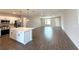 Open-concept living room showcasing a kitchen island with modern appliances and stylish finishes at 10107 Sw 41St Ave, Ocala, FL 34476