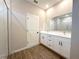 Bathroom featuring dual sink vanity with white cabinets, matte black hardware, and a glass enclosed shower at 10131 Sw 41St Ave, Ocala, FL 34476