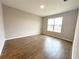 Bright bedroom showcasing wood-look tile flooring and a large window providing natural light at 10131 Sw 41St Ave, Ocala, FL 34476