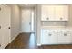 Inviting entryway with stylish wood-look tile flooring, white cabinets, and a coat closet at 10131 Sw 41St Ave, Ocala, FL 34476