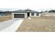 New single-story home with a two-car garage, stone accents, and well-maintained lawn at 10131 Sw 41St Ave, Ocala, FL 34476