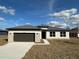 Charming single-story home with stone accents, gray roof, and two-car garage at 10131 Sw 41St Ave, Ocala, FL 34476