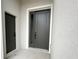 Modern front door with sidelight, set in a stucco entryway, and a dark color at 10131 Sw 41St Ave, Ocala, FL 34476