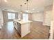 Open-concept kitchen with island and stainless steel dishwasher flowing to an open living space at 10131 Sw 41St Ave, Ocala, FL 34476