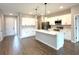 Open kitchen featuring a center island, stainless steel appliances, and white cabinetry at 10131 Sw 41St Ave, Ocala, FL 34476