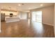 Open-concept living space featuring a modern kitchen, wood-look tile flooring, and sliding glass doors to the backyard at 10131 Sw 41St Ave, Ocala, FL 34476