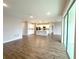 Open-concept living room and kitchen with abundant natural light, island and tile floors at 10131 Sw 41St Ave, Ocala, FL 34476