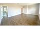 Spacious main bedroom with wood-look tile flooring and an ensuite bathroom with a glass-enclosed shower at 10131 Sw 41St Ave, Ocala, FL 34476