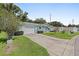 Charming single-story home with a well-manicured lawn, an attached garage, and tidy landscaping at 10593 Se 174Th Loop, Summerfield, FL 34491