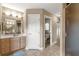 Bathroom featuring a large vanity, toilet, walk-in shower, and a closet, all tied together with neutral tile flooring at 2215 Se 24Th Ave, Ocala, FL 34471