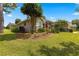 Attractive single-story home with a well-kept lawn, beautiful landscaping, and red accents on the shutters at 2215 Se 24Th Ave, Ocala, FL 34471