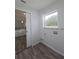 Laundry room with wood-look flooring and a window at 238 Locust Pass Loop, Ocala, FL 34472