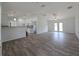 Spacious living room with wood-look flooring and access to the kitchen at 238 Locust Pass Loop, Ocala, FL 34472