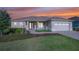 Charming single-story home boasts a manicured lawn, a paver walkway, and a pristine three-car garage at 9400 Sw 106Th Ave, Ocala, FL 34481