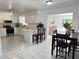 Well-lit kitchen boasts white cabinetry, quartz countertops, and stainless steel appliances at 11 Cedar Trace Crse, Ocala, FL 34472