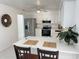 Modern kitchen features white cabinets, quartz countertops, and stainless steel appliances at 11 Cedar Trace Crse, Ocala, FL 34472