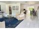 Bright living room features tile floors, a stylish rug, and an open floor plan at 11 Cedar Trace Crse, Ocala, FL 34472