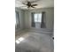 Bedroom with gray walls, neutral carpet, ceiling fan, and natural light from the windows at 6253 Sw 106Th Pl, Ocala, FL 34476