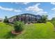Expansive backyard features a well-manicured lawn and a screened-in lanai for outdoor enjoyment at 8445 Sw 93Rd Cir, Ocala, FL 34481