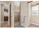 Tiled walk-in shower with a window, seat and handrail, is adjacent to the Primary bathroom at 8445 Sw 93Rd Cir, Ocala, FL 34481