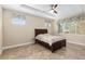 Comfortable bedroom featuring tray ceiling, large window, and tile flooring at 8445 Sw 93Rd Cir, Ocala, FL 34481
